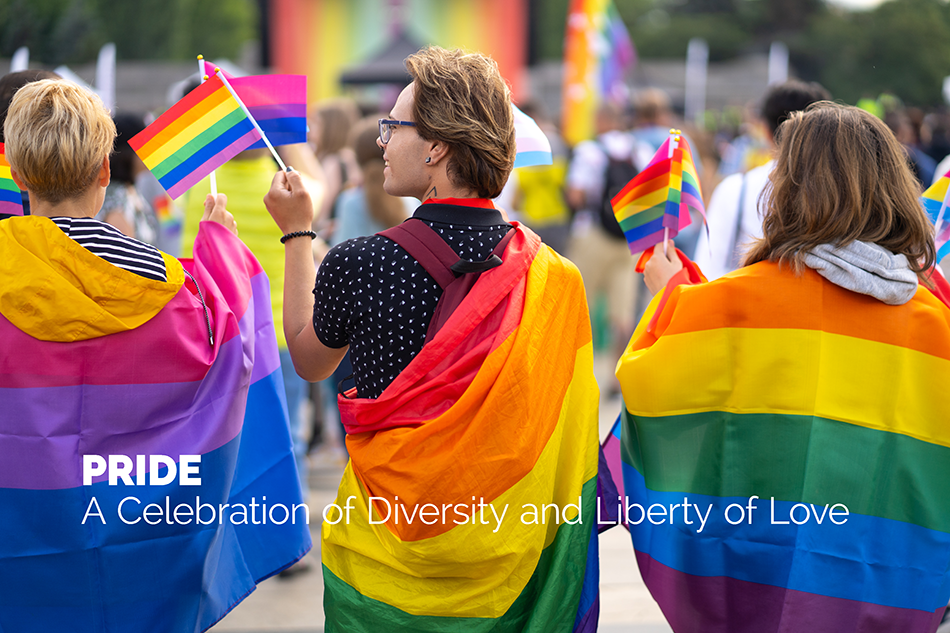 A group of people wrapped in and carrying rainbow flags in a Pride parade